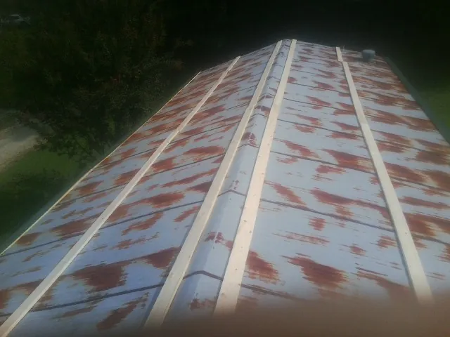 Rusted metal roof panels with new wood purlins before replacement — Storm Damage Roof Repair in Himrod by Roofing Brothers