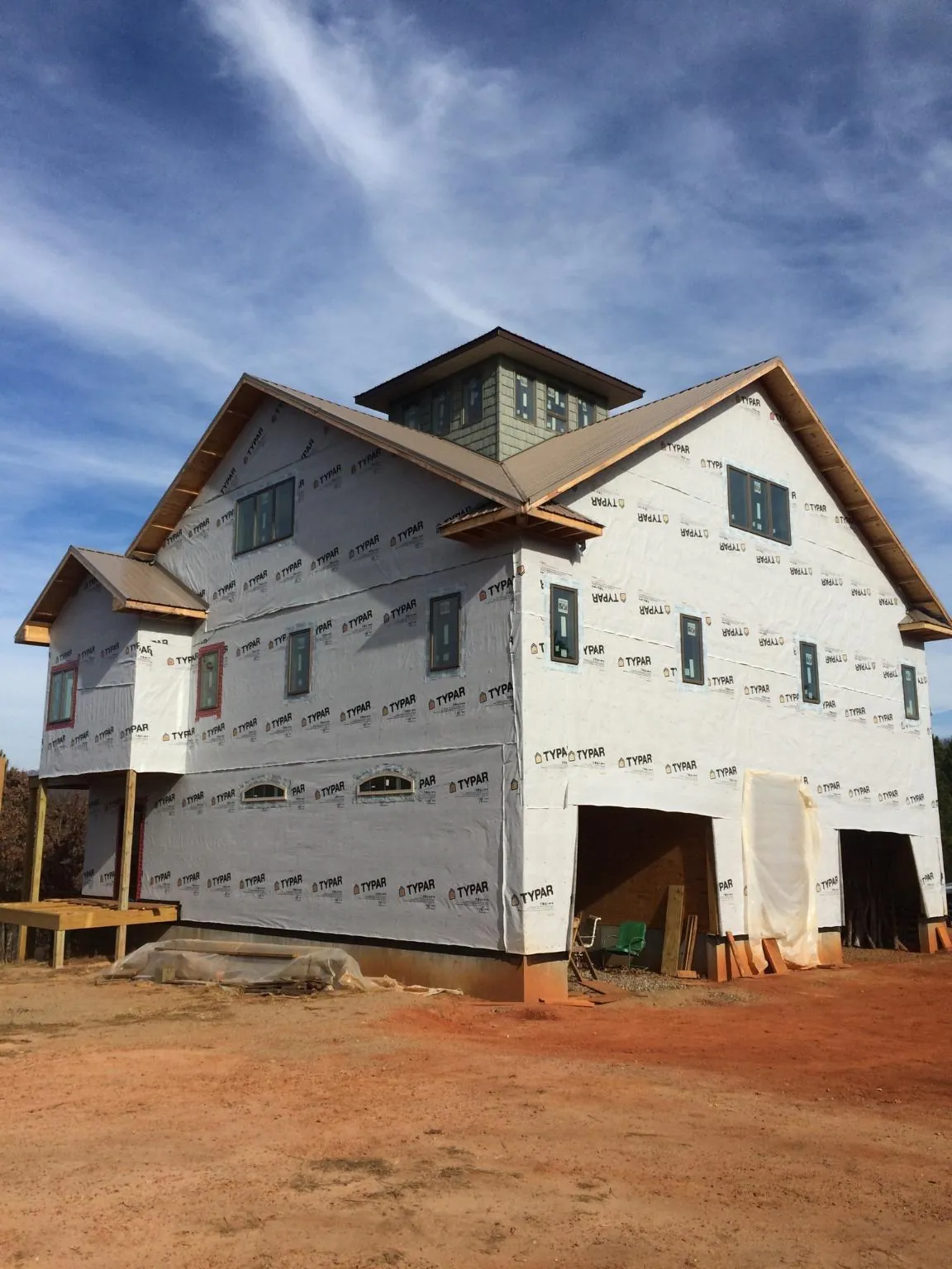 New two story house under construction with a cupola and gabled roofs in Himrod